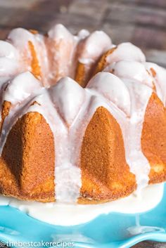 a bundt cake with white icing sitting on a blue and white platter