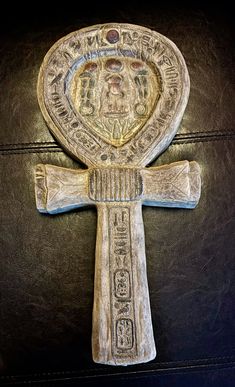 the cross is made out of wood and has an intricate design on it's side