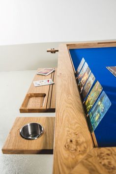 a wooden table topped with lots of drawers and bowls next to a metal dog bowl