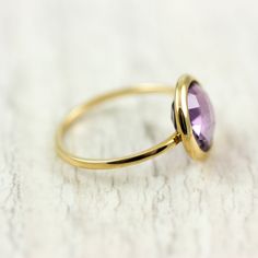 Amethyst ring in 14K solid gold. A gold stacking ring with a natural amethyst gemstone. A perfect gold ring for women who love colors and elegant jewelry. And, note; purple amethyst is the birthstone of February. The best gift for her. 100% handcrafted with love! D E T A I L S ● Metal: 14K solid gold, 14K white gold or 14K rose gold ● Gemstone: Purple Amethyst, briolette cut ● Stone Diameter: 10mm (0.5in) R I N G ∙ S I Z I N G For General Reference: ● we use standard US Ring Sizing ● an average 14k Gold Amethyst Ring With Bezel Setting For Wedding, Wedding Amethyst Ring With Bezel Setting In 14k Gold, Formal Gold Amethyst Ring With Bezel Setting, Formal 14k Gold Crystal Ring With Bezel Setting, Gold Amethyst Stackable Ring Fine Jewelry, Gold Amethyst Stackable Ring In Fine Jewelry Style, Gold Stackable Amethyst Ring In Fine Jewelry Style, 14k Gold Hallmarked Birthstone Ring, 14k Gold Amethyst Ring With Bezel Setting For Promise