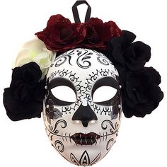 a white and black mask with flowers on the top, wearing a flowered headband