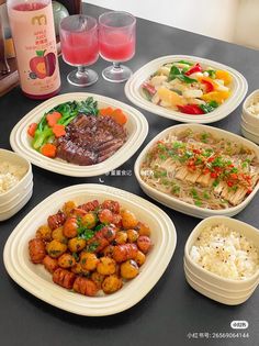 a table topped with plates and bowls filled with food