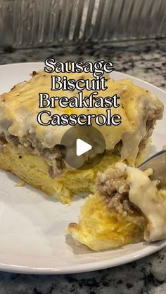 sausage biscuit breakfast casserole on a white plate with a knife and fork