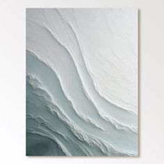 an abstract painting with white and grey colors on the wall, showing waves in water