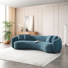 a blue couch sitting on top of a white rug