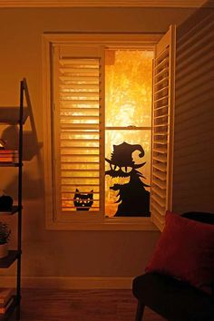 a cat sitting in the window sill next to a book shelf with books on it