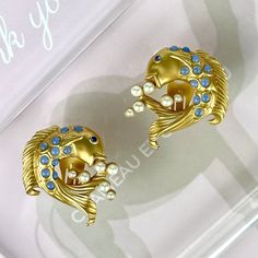 "Vintage 90s Elizabeth Taylor For Avon Sea Shimmer Koi Fish Earrings SIGNED. Gorgeous Vintage 90s Elizabeth Taylor For Avon Sea Shimmer Koi Fish Clip On Earrings. Exquisite Detail To These Fantastical Figural Koi Fish Earrings. Made Of Rich Satin Matte Gold Plating And Beautiful Accents, These Elizabeth Taylor Earrings Are More Than Simply Spectacular, They Are Over The Top Scrumptious. Each Whimsical Koi Fish Is Embellished With Bezel Set Translucent Pale Blue Cabochons Meticulously Placed On T Fish Earrings, Avon Vintage, Blowing Bubbles, Crystal Eye, Elizabeth Taylor, Koi Fish, Blue Crystals, Matte Gold, Pale Blue