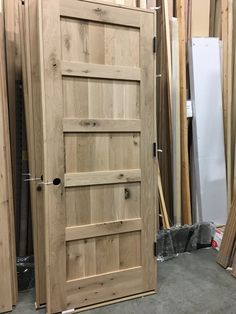 an unfinished wooden door in the process of being installed