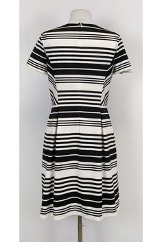 Be bold in stripes with this darling dress! Perfect for day time wear, you can style it with red accessories and chic flats. Size 10 67% polyester, 28% viscose, 5% spandex Made in U.S.A Rounded neckline Short sleeve Back zipper Lined Fitted at waist As is: Undone seam on right sleeve Bust 34.5" Waist 30" Shoulder to hem 37" Chic Dresses With Horizontal Stripes, Chic Striped Dresses For Day Out, Black Vertical Stripes Summer Dress, Contrast Stripe Dresses For Workwear, Chic Fitted Dress With Contrast Stripes, Fitted Short Sleeve Dress With Vertical Stripes, Elegant Striped Short Sleeve Dress, Fitted Dress With Vertical Stripes And Short Sleeves, Black Dresses With Contrast Stripes