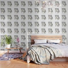 a bedroom scene with focus on the bed and wallpaper that has an image of a cat