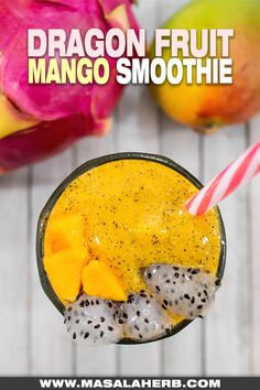 dragon fruit mango smoothie in a glass with a straw and two pieces of fruit on the side