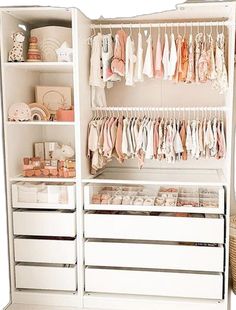 a white closet filled with lots of clothes and baby goods on shelves next to a basket