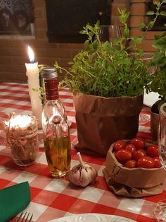 the table is set with tomatoes, garlic and wine bottles for dinner guests to enjoy