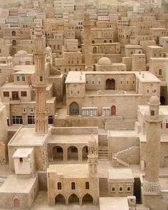 an aerial view of a city made out of clay blocks and mud bricks, with buildings in the background