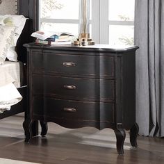 Upgrade your bedroom with the Chelmsford Nightstand, a stunning addition that combines timeless design with practical features. Crafted with meticulous attention to detail, this nightstand exudes sophistication and offers the perfect blend of style and functionality. Its exquisite black antique finish and premium wood and veneer construction make it a must-have for any bedroom. Elevate your nighttime routine and enjoy the convenience of having your essentials close at hand while adding a touch o Bedroom Table Decor Ideas, Bedroom End Table, Black Farmhouse Nightstand, Dark Academia Nightstand, Oversized Nightstand, Antique Bedside Table, Nightstand Black Bottom Stained Top, Gold Accent Furniture, Black French Country Nightstand