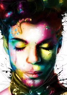 a man's face with colorful paint splattered on it