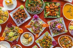 a table topped with lots of plates filled with food