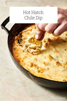 a person dipping some food into a skillet with the words hot hatch chile dip above it