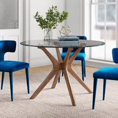 a glass table with blue chairs around it