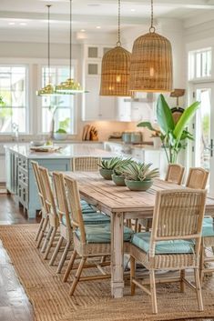 a dining room table with chairs and plants on top of it in front of an open kitchen