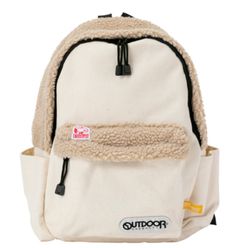 a white backpack with a furry lining on the front and side pocket, which has a zipper