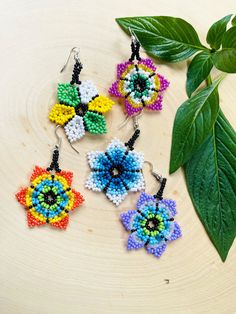 Flower Earrings in multiple colors. These earrings reflect the cultural traditions of indigenous artisans from Chiapas Mexico.  Whether you are looking for everyday jewelry or statement pieces, we got you covered! These beautiful beaded earrings are unique, lightweight, and perfect for any occasion.  They also make great gifts.  * If you would like some more pictures of these lovely earrings don't hesitate to message me. As a special thank you every shipment will receive a FREE GIFT!! Thank you Adjustable Multicolor Earrings With Flower Charm, Adjustable Multicolor Flower Charm Earrings, Multicolor Flower Shaped Jewelry With Colorful Beads, Bohemian Multicolor Flower Charm Earrings, Multicolor Flower-shaped Earrings With Colorful Beads, Bohemian Multicolor Flower Shaped Jewelry, Multicolor Beaded Flower Earrings With Flower Charm, Bohemian Multicolor Earrings With Flower Charm, Handmade Multicolor Beaded Earrings In Flower Shape