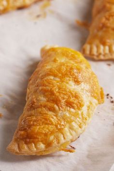 three pastries sitting on top of a piece of paper