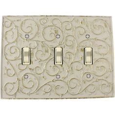 an ornate light switch cover with two lights on each side and one outlet in the middle