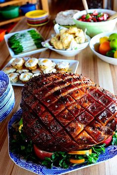 a table topped with plates and bowls filled with different types of food on top of it