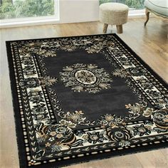 a black rug with an ornate design on it