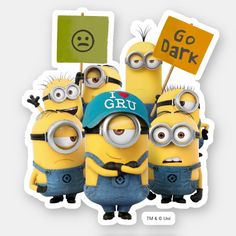 a group of minion characters holding signs and standing next to each other in front of a sign that says go dark