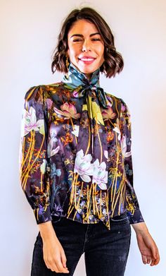 Romance is in full bloom in Trisha's spring/summer 2019 Collection. This beautiful pure silk blouse is decorated with delicate flowers that cascade down the body. Fun design elements are emphasized by a front tie and high collar. There is nothing like a touch of romance intertwined with the fresh bloom of spring. This blouse can be worn all season and very elegantly or casually. Don't be a stranger! Call us, text us, email us and we will gladly help you find the perfect dress! Email: Trisha@tris Romantic Essence, Cascading Flowers, Work Outfits Women Summer, London Fashion Week Street Style, Summer Work Outfits, London Street Style, Delicate Flowers, Bow Blouse, Luxury Silk