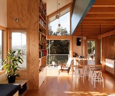 a living room filled with furniture next to a window covered in wood planks and windows