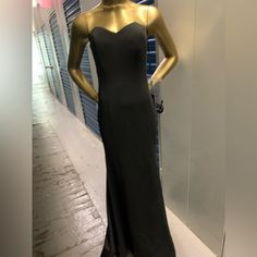 a mannequin is dressed in black and gold