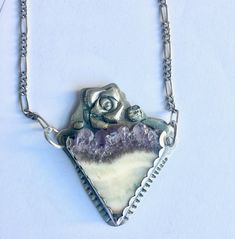 "another glorious stone in a piece by me. not sure what the ivory-yellow part of the stone is, but the top is amethyst crystal, and the combination of the colors is dreamy. my photos do not do the stone justice, but i've set it in 960 silver and attached a sterling chain to either side. a bit of texture, a bit of patina. height of pendant: 2\" width of pendant: 1 and 11/16\" length of pendant plus chain: just shy of 19 and 3/4\"" Rough Gemstone Jewelry, Crystal Top, Gold Diamond Band, Sterling Necklaces, Rough Gemstone, Gold Pattern, My Photos, Moonstone Ring, Amethyst Crystal