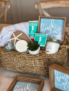 a basket filled with items sitting on top of a table next to two framed pictures