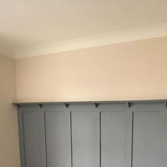 an empty room with blue painted walls and wooden floors