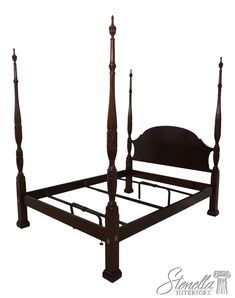 a wooden bed frame with four posts and headboard is shown in this image, it's dark wood