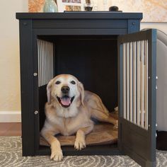 a dog laying in its crate on the floor with it's mouth open and tongue out