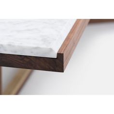 a white marble top on a wooden shelf