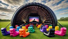 an inflatable movie theater is set up on the grass