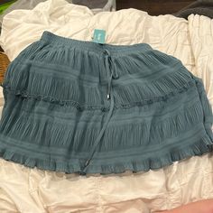 Cyan Ruffle Skirt. Never Been Worn And Still Has Tags. Has Drawstring In Front To Adjust Waist Pleated Tiered Skirt Bottoms For Beach, Casual Flowy Bottoms For Brunch, Blue Ruffle Hem Skirt For Vacation, Casual Pleated Mini Skirt For Beach, Blue Vacation Bottoms With Ruffle Hem, Blue Ruffle Hem Bottoms For Vacation, Vacation Blue Bottoms With Ruffle Hem, Casual Pleated Skirt Bottoms For Brunch, Casual Pleated Skirt For Brunch