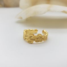 This ring draws inspiration from the intricate flower pattern adorning a Chinese bronze urn from the Qing Dynasty (1636-1912). Elaborate floral details form a simple and elegant design. Crafted from pewter and plated in 18K gold, it is an adjustable fit and made in the U.S.A. Materials: Pewter with 18K gold plating, nickel free Ring is adjustable - sizes 5-9. Made in USA Original design by Museum Reproductions Elegant Handmade Gold Flower Ring, Ceremonial Adjustable Gold Engraved Ring, Elegant Gold Engraved Ring In Brass, Ornate Gold Engraved Ring For Ceremonial Occasions, Gold-plated Flower Open Ring, Gold Plated Open Flower Ring, Ornate Handmade Gold Rings, Ornate Gold Filigree Ring For Ceremonies, Gold Engraved Flower Ring For Wedding