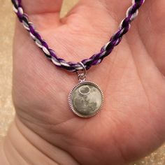 Show your asexual or demisexual pride with this friendship bracelet with a moon charm! This hand-twisted minimalist bracelet in purple, white, gray, and black - the colors of the asexual flag - is easy to adjust to your wrist or ankle. The soft, high-quality cotton used is lightweight and colorfast so you can wear it non-stop. Charm is pewter and glass. Put them on by putting the end knot through the very end of the twist. They can be shortened by either trimming the knot end or putting the knot Adjustable Purple Moon Phase Jewelry, Ace Flag, Pride Bracelet, Asexual Pride, Twisted Bracelet, Minimalist Bracelet, Moon Charm, Lgbt Pride, Pride Month