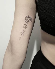 a woman's arm with a tattoo that says love on it and a rose