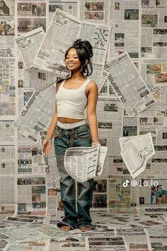 a woman standing in front of a pile of newspapers