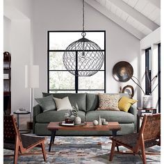 a living room filled with lots of furniture next to a large window and a table