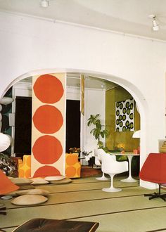 a living room filled with furniture and lots of books