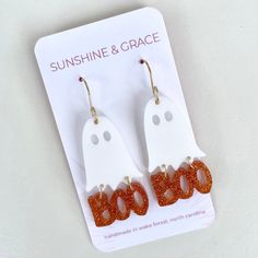 These scary cute earrings feature 'BOO' made of orange glitter acrylic and a solid white acrylic ghost. Lightweight and fun! Product Features *2.5" long x 1" wide *Handmade  *Lightweight acrylic *Gold plated wire. Lead and nickel free. FOLLOW US!! 👍Follow us on Instagram or Facebook for sneak peaks and promotions! @sunshineandgraceearrings  Don't forget to tag us! We love seeing our earrings on you! Spooky Earrings, Scary Cute, Halloween Acrylic, Ghost Earrings, Earrings Halloween, Orange Glitter, Glitter Acrylic, Orange Earrings, Glitter Acrylics