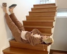 a woman laying on the stairs with her feet up